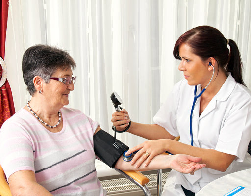 nurse taking senior blood pressure